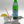 cat-shaped coasters holding glass of sparkling water with lemon and a straw