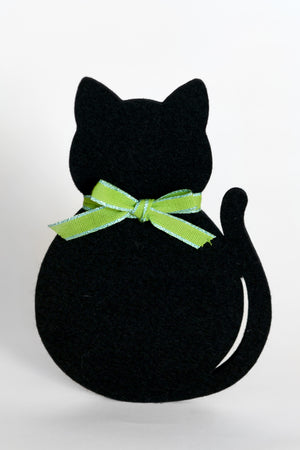 A black felt cat-shaped decoration or coaster with a bright lime green ribbon bow tied around its neck, shown against a plain white background.